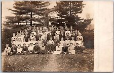 Group Picture Boys and Girls Pine Trees at Back Postcard picture