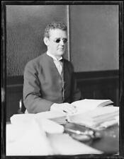 Mr. McWilliams, a blind barrister, sitting at his desk with a book - Old Photo picture