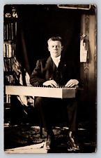 Antique Real Photo RPPC Beefy Blind Man Plays Big Musical Wooden Lap Instrument picture