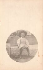 Vintage Postcard Baby Sitting On The Side Wearing Black Hat And White Shirt RPPC picture