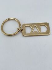 Vintage Avon Dad keychain vertical textured lines cutout letters gold tone 1.5