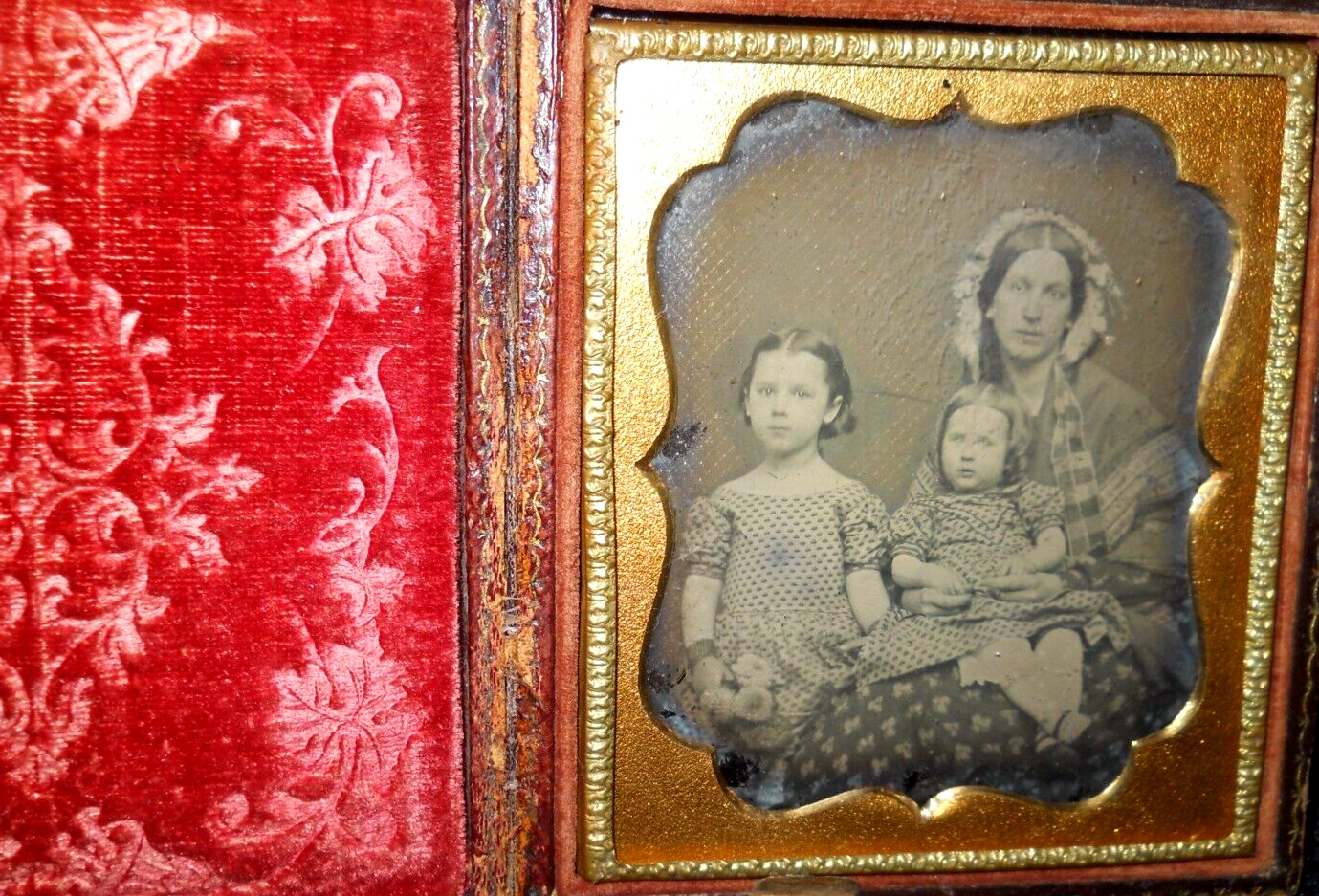 1/6th size Ambrotype of family in full case, split at hinge