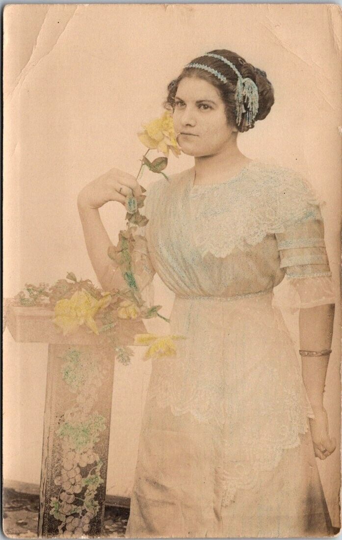 RPPC Woman Smelling Yellow Rose Column c1920s Tinted photo postcard FQ4