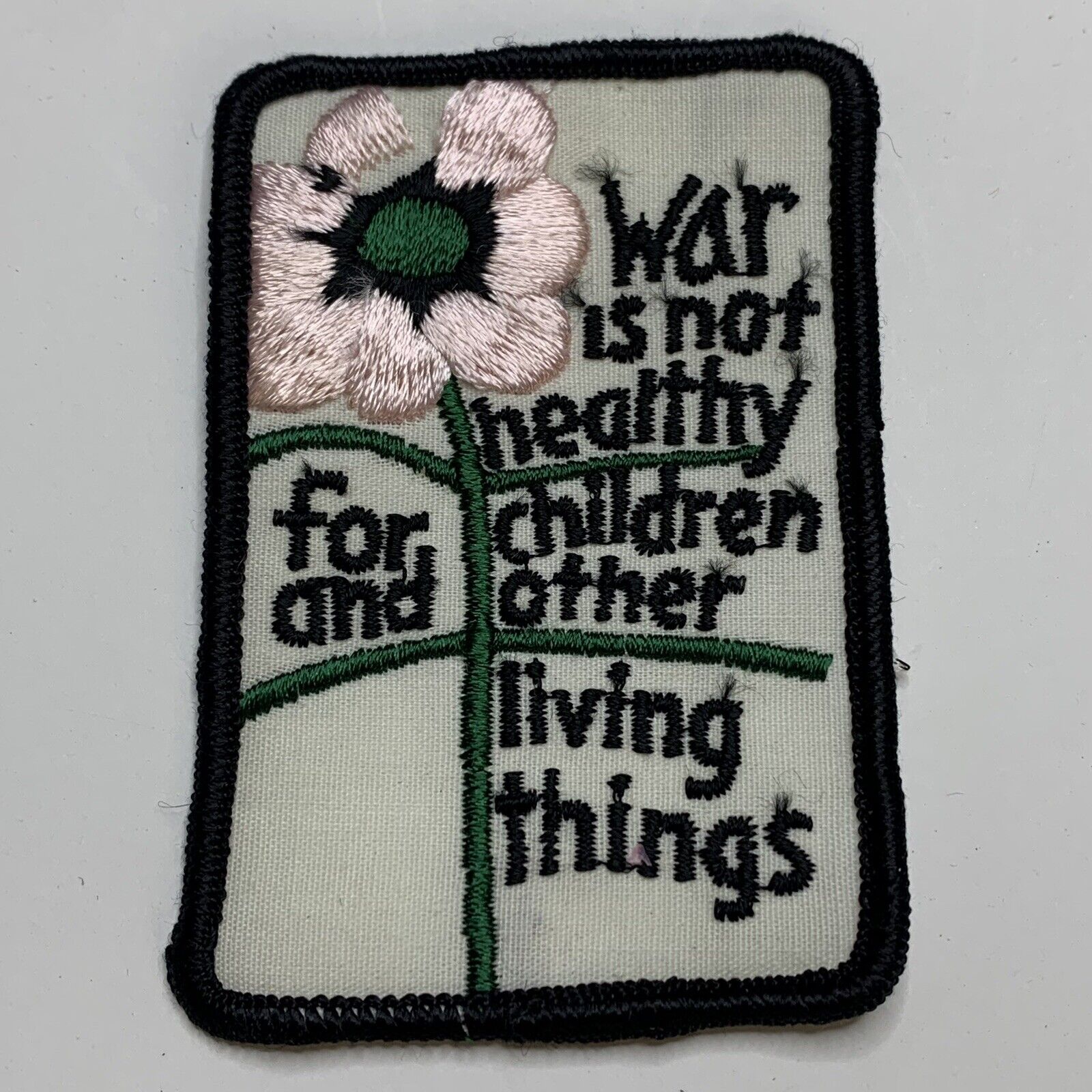 VINTAGE Anti-war Peace WAR IS NOT HEALTHY Pink Flower Sew On Patch NEW