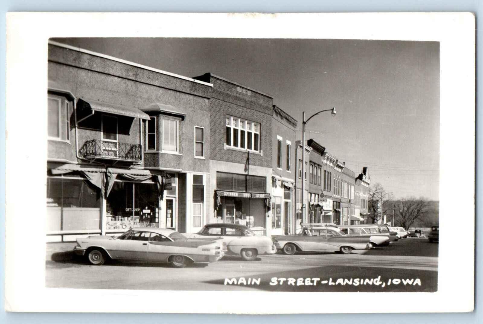 Lansing Iowa IA Postcard RPPC Photo Main Street Spinner Drug Store Cars c1910's