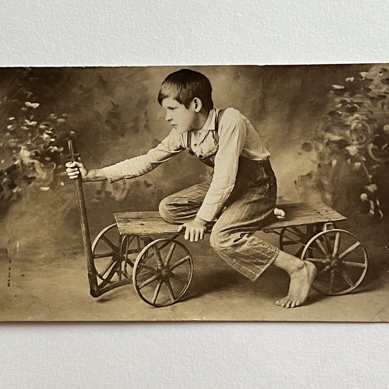 Antique RPPC Real Photograph Postcard Boy Overalls On Wagon Barefoot ID Clyde