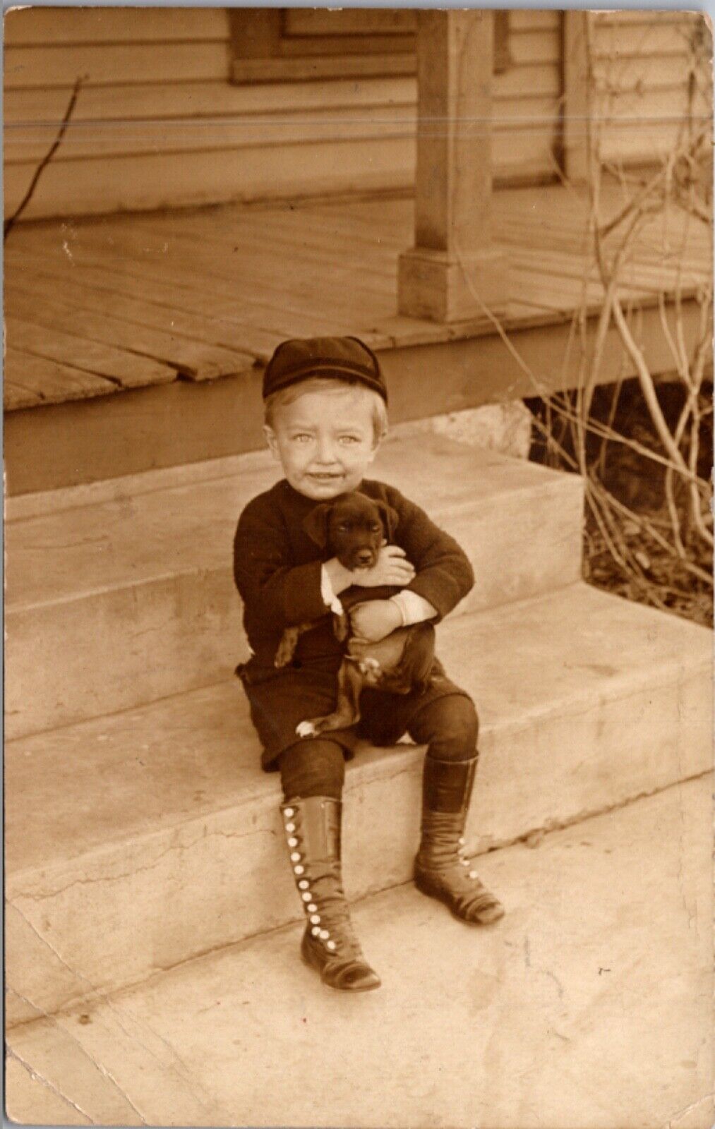 Real Photo Postcard Little Boy Holding Puppy on a Porch Clarence Lindsay Kansas