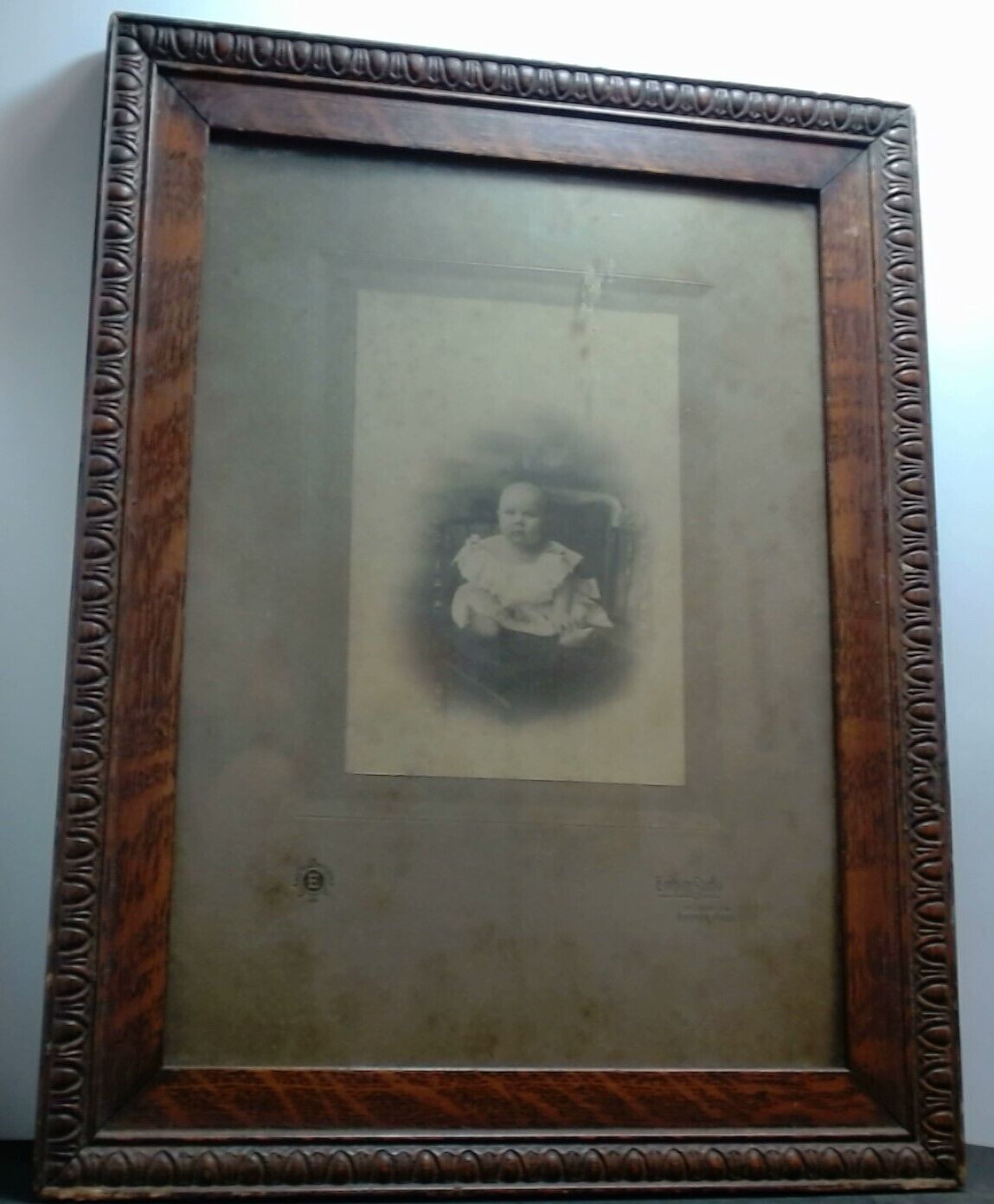 Antique Large-Eyed Baby Photo in Decorative Wood Frame