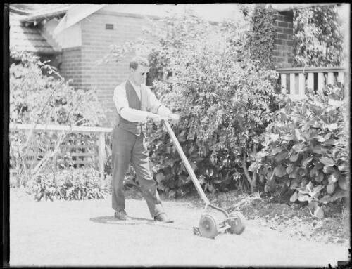 Mr. McWilliams, a blind barrister, mowing the lawns at his home at - Old Photo