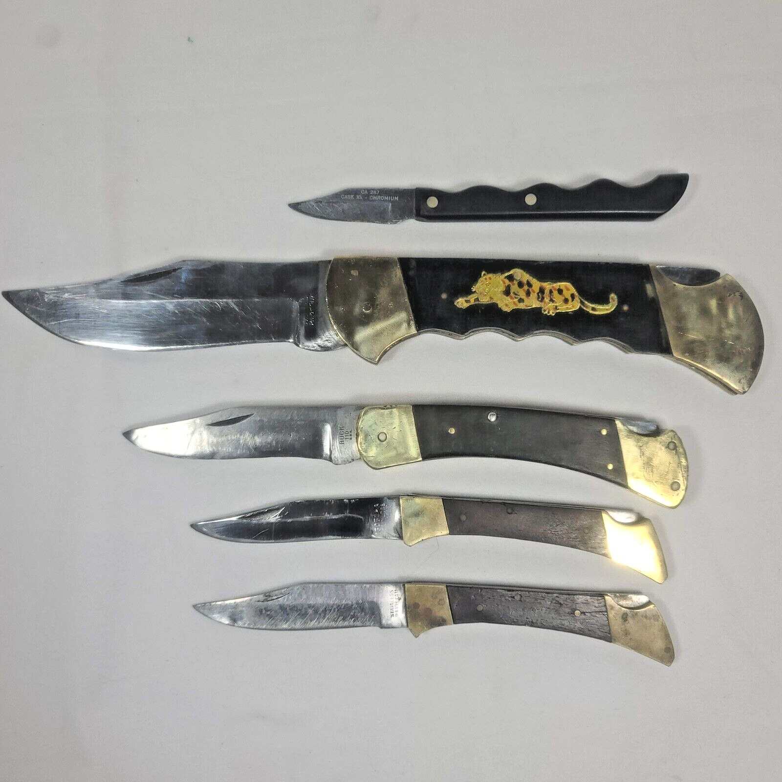 Lot of knives BUCK 110, Pakistan Folding Knives, and one random one.