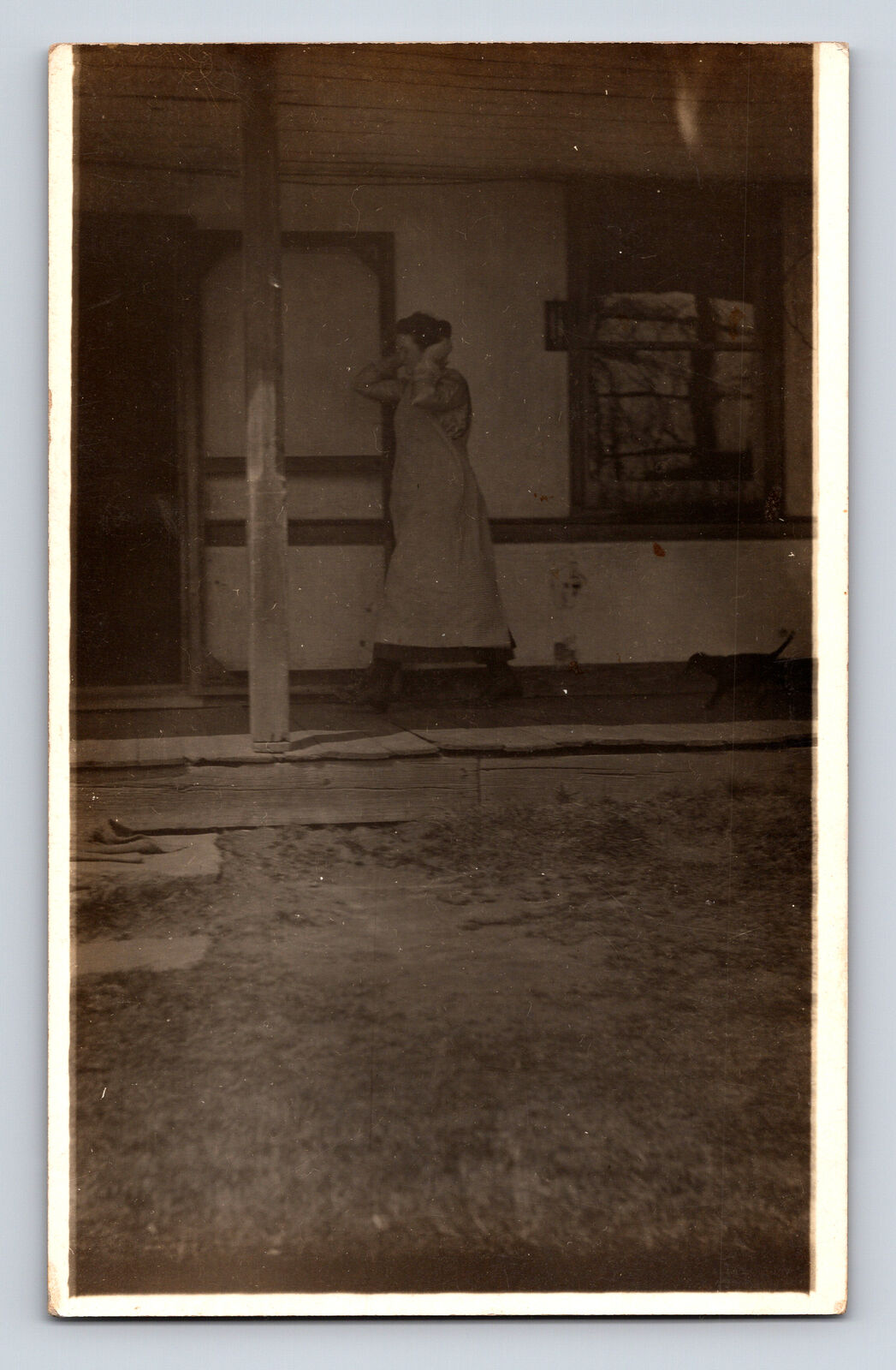 RPPC Spooky Photo of Woman on Porch Holding Ears? Postcard